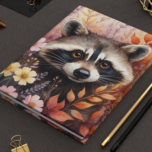 Whimsical Raccoon Journal, Raccoon Notebook Hardcover, Cute Animal Journal with Autumn Floral Design, Illustrated Diary for Animal Lovers