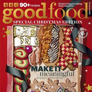May include: A Christmas-themed magazine cover featuring a festive food spread with a variety of cookies, pastries, and sweets. The magazine is titled "goodfood" and the cover text reads "Special Christmas Edition" and "Make it meaningful. Recipes for caring & sharing".