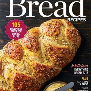 May include: A magazine cover for Taste of Home Bread Recipes featuring a golden brown braided loaf of bread with a bowl of butter and a knife on a dark background. The cover text reads "105 Foolproof Faves for Baking Bliss" and "Delicious Everything Bread, p. 17".