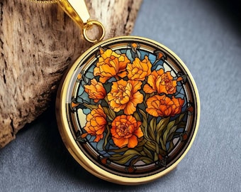 May include: A gold necklace with a round pendant featuring a stained glass design of orange flowers on a blue background.