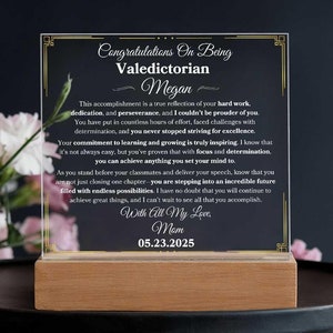 May include: A black and gold framed acrylic plaque with a congratulatory message for a valedictorian named Megan. The message includes the date 05.23.2025 and the words "With All My Love, Mom".