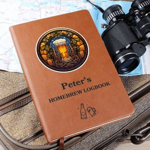 May include: A brown leather-bound journal with the title "Peter's Homebrew Logbook" printed on the front. The cover features a stained glass design of a beer glass with hops and vines.