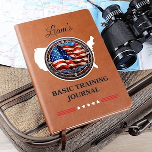 May include: A brown leather journal with the text "Liam's Basic Training Journal" and a stained glass design of an American flag.