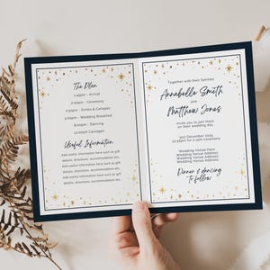 May include: A wedding invitation with a navy blue border and a white background. The invitation features a gold star pattern and the text "Annabelle Smith and Matthew Jones" with the date "12 December 2023".