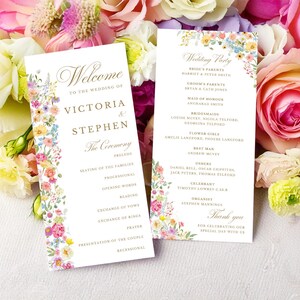 Peut inclure: Deux programmes de mariage blancs avec du texte doré et des illustrations florales aquarelles colorées sur les bords. Le texte indique Welcome to the wedding of Victoria & Stephen, The Ceremony et Wedding Party avec des noms listés.