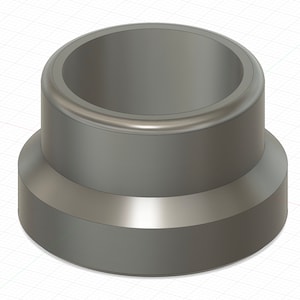 Puede incluir: Un objeto cilíndrico de plástico gris con una base ligeramente más ancha y un borde elevado alrededor de la abertura superior.