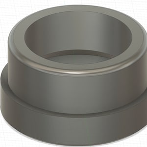 May include: A gray plastic ring with a raised lip around the top edge. The ring is about 1 inch in diameter and 1/2 inch tall.