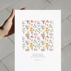 May include: A printable art print with a watercolor floral pattern and a quote from 1 Thessalonians 4:11. The quote reads: "Aspire to lead a quiet life, to mind your own business, and to work with your own hands."
