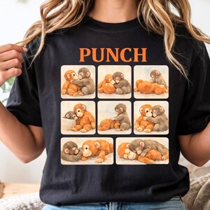 A black t-shirt with a collage of nine images depicting various monkey interactions, including hugging, cuddling, and playing.