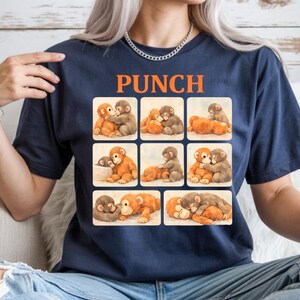 A woman wearing a blue t-shirt with a collage of images depicting various animals, including elephants, dogs, and cats.