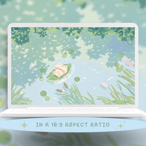 May include: A white laptop displays a serene digital illustration of a cat floating on a lily pad in a pond. The background features a soft, blurred depiction of trees and water. The text "IN A 16:9 ASPECT RATIO" is at the bottom.