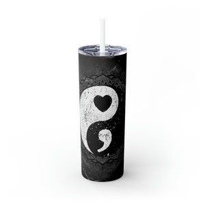 May include: A black and white stainless steel tumbler with a yin yang symbol and a heart in the white half. The tumbler has a black mandala design at the top and bottom.