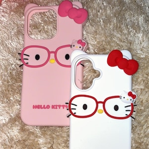 May include: Two phone cases featuring Hello Kitty designs. One is pink with a pink bow and glasses, the other is white with a red bow and glasses. Both cases have the words "Hello Kitty" printed on them.