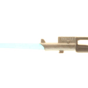 May include: A silver and black lightsaber toy with a light blue blade. The lightsaber has a handle with a button and a small hole on the side.