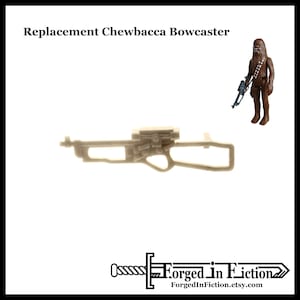 May include: A beige plastic replacement bowcaster for a Star Wars action figure. The bowcaster has a detailed design with a scope and a handle.