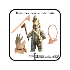 May include: Replacement accessories for a Teebo action figure, including a spear, a headpiece, and a satchel. The figure is a light brown color with a detailed design. The text "Forged in Fiction" is also visible.