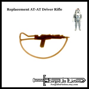 May include: A brown plastic replacement rifle for a Star Wars AT-AT driver action figure. The rifle has a curved handle and a black barrel.