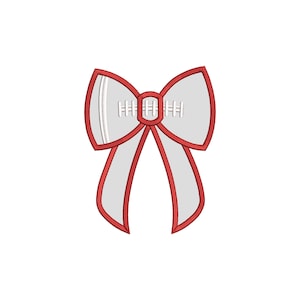 May include: A white football-shaped bow with red ribbon tails. The football has white stitching details.