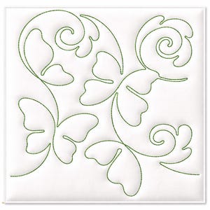 May include: A white square textile with a green embroidered design. The design features stylized leaves, butterfly shapes, and swirling patterns. The embroidery is a continuous line, creating a flowing, organic aesthetic. The textile is likely for quilting or embroidery projects.
