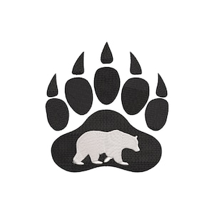 May include: Black bear paw print with a white bear silhouette inside. The paw print is a simple design with five toes.