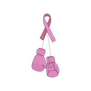 May include: Pink boxing gloves hanging from a pink ribbon. The ribbon is tied in a bow at the top.
