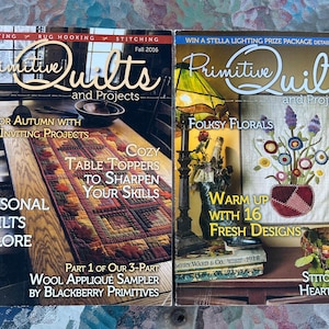May include: Two issues of Primitive Quilts and Projects magazine. The left cover, Fall 2016, shows a table runner with autumn leaves. The right cover, Spring 2018, features a floral quilt, a lamp, and a basket. Both magazines display text.