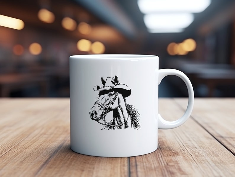 May include: White ceramic mug with a black and white illustration of a horse wearing a cowboy hat. The horse is looking to the left.