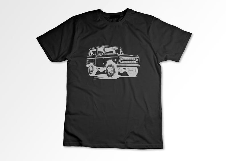 May include: A black t-shirt with a white outline of a vintage Ford Bronco.