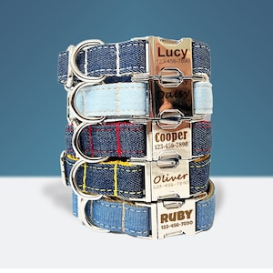 May include: A stack of personalized denim dog collars with silver metal buckles. Each collar is embroidered with a different color thread and features a name and phone number. The names include Lucy, Daisy, Cooper, Oliver, and Ruby.
