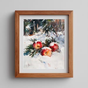 May include: A framed oil painting depicts three red apples dusted with snow, resting on evergreen boughs in a snowy landscape. The artwork is set in a wooden frame, showcasing a winter still life.