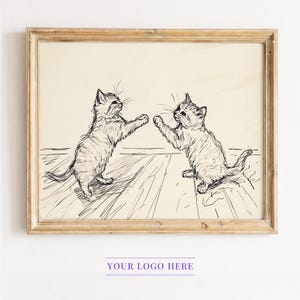 May include: A framed vintage-style print featuring two playful kittens in a sketch-like illustration. The kittens are depicted in a light beige color, with a wooden frame. The artwork is set against a light background, with the text "YOUR LOGO HERE" at the bottom.