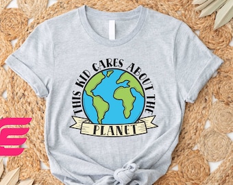 May include: Gray t-shirt with a graphic of a blue and green Earth with the text "This Kid Cares About The Planet" in a white banner.