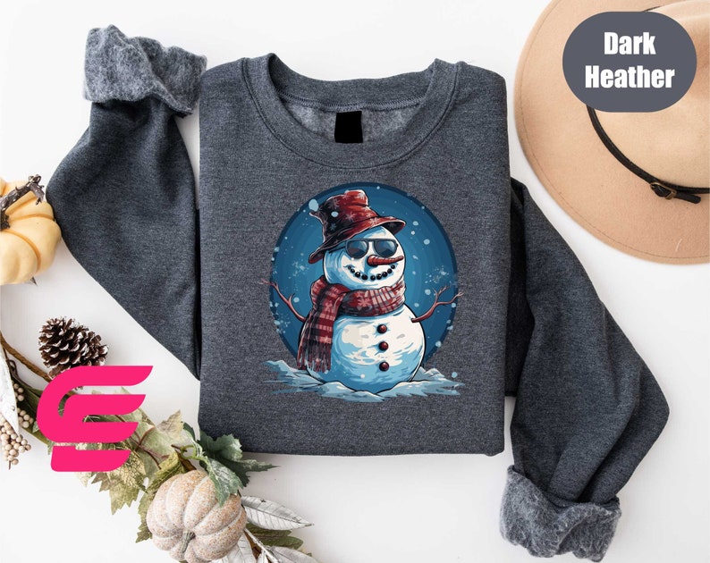 a sweater with a snowman wearing a hat and scarf