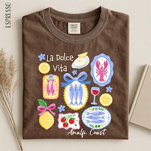 a brown t-shirt with a variety of colorful illustrations and text related to Italian cuisine and coastal regions.
