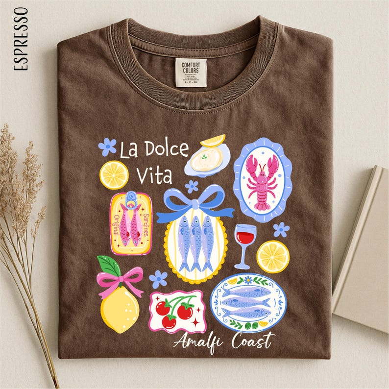 a brown t-shirt with a variety of colorful illustrations and text related to Italian cuisine and coastal regions.