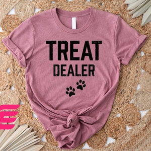 a t - shirt that says treat dealer with a dog's paw on it