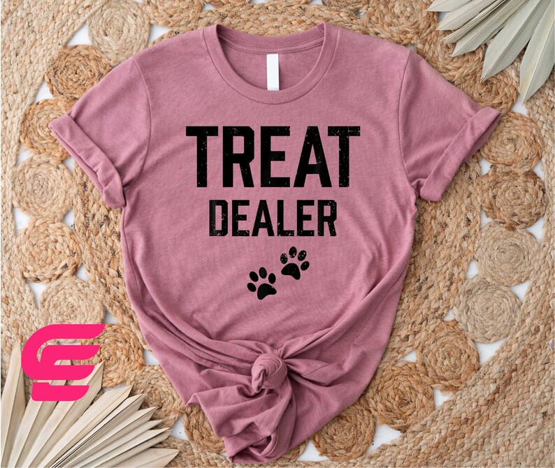 a t - shirt that says treat dealer with a dog's paw on it