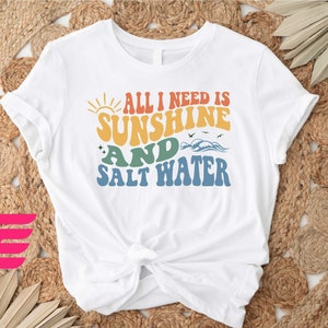 a t - shirt that says all i need is sunshine and salt water