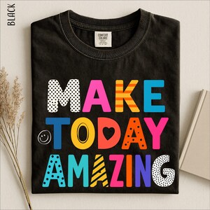 a black t-shirt with a colorful, playful text design that says "MAKE TODAY AMAZING".