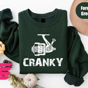 a green shirt with the words cranky printed on it
