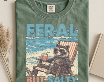 Funny Beach Raccoon T-Shirt, Feral But Salty Summer Vibes Shirt, Retro Coastal Humor Gift, Summer Vacation Graphic Unisex T-Shirt