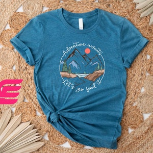 a blue t - shirt with a picture of a mountain on it