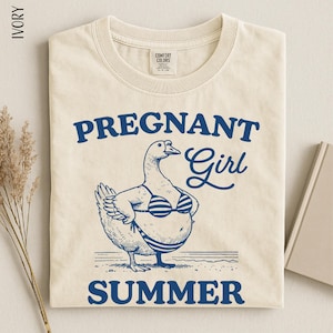 a t-shirt with a graphic design depicting a cartoon duck wearing a bikini top and the text "Pregnant Girl Summer" printed on it.