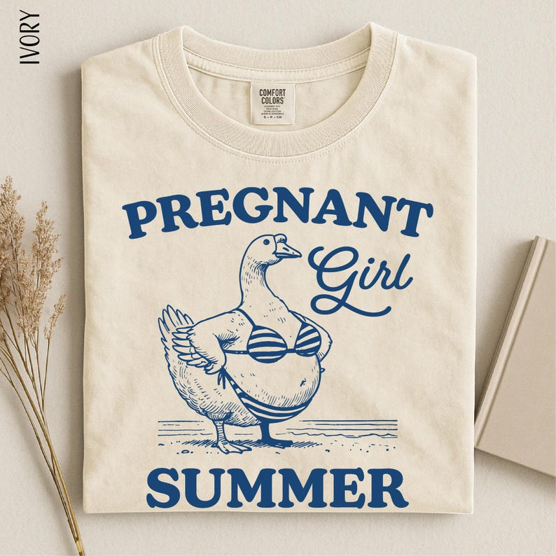 a t-shirt with a graphic design depicting a cartoon duck wearing a bikini top and the text "Pregnant Girl Summer" printed on it.