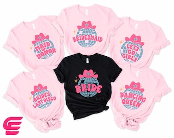 May include: Set of six pink and black t-shirts with a disco ball and cowboy hat design. The shirts feature the text "Bride", "Bridesmaid", "Maid of Honor", "Let's Go Girls", "Bride's Last Disco", and "Dancing Queen".