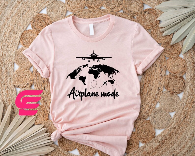 a pink t - shirt with an airplane map on it