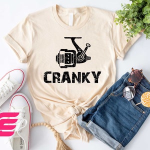 a t - shirt that says cranky next to a pair of shorts