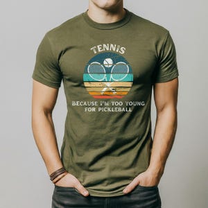 a man wearing a tennis racket t - shirt