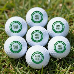 May include: Six white golf balls with dimpled surfaces, each featuring a circular green emblem. The text inside the green circle reads "IF FOUND PLEASE HIT BETTER THAN" above "NAME HERE" and a small graphic of two crossed golf clubs.