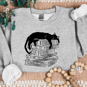 Cat Crewneck Sweatshirt, Cat Sleeping On Books Cute Printed Jumper, Black Kitten Bookish Sweater, Cat Owner Pullover Jumper, Book Lover Gift